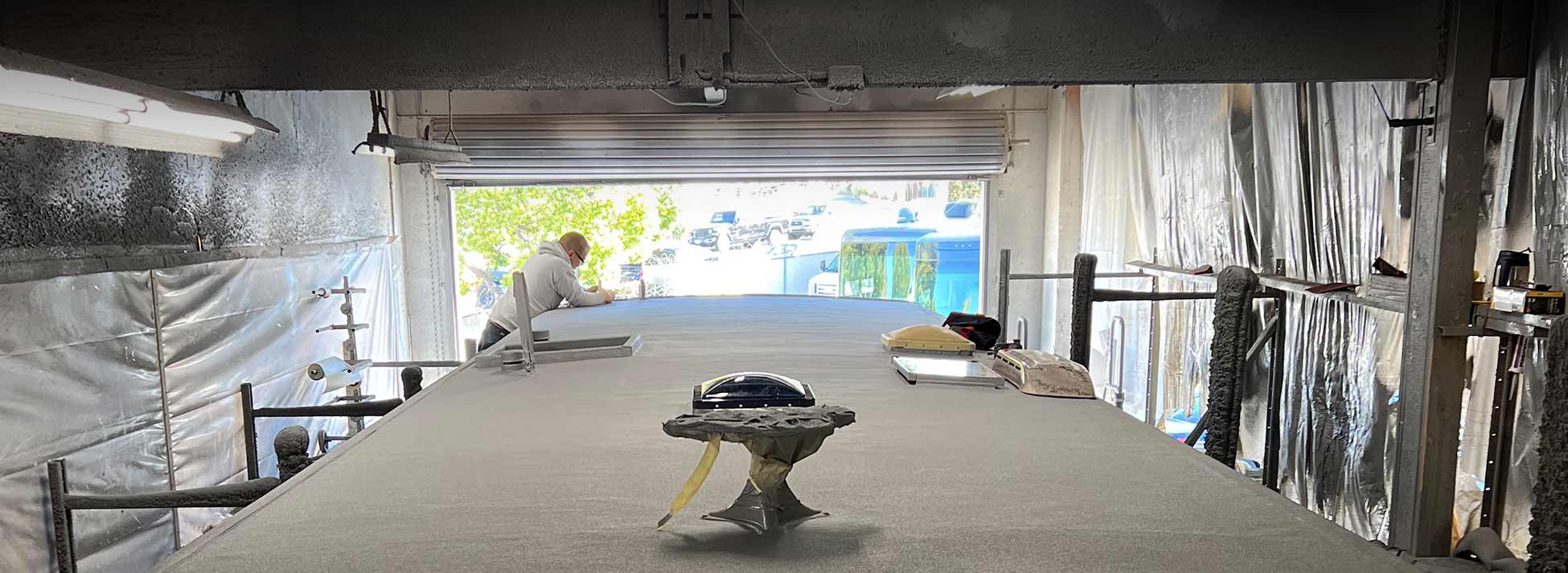Technician probing RV roof membrane to determine if repair or full replacement is needed in San Diego